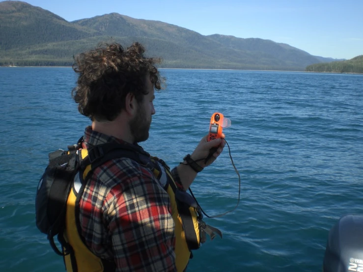 a man taking a pograph while standing in the water