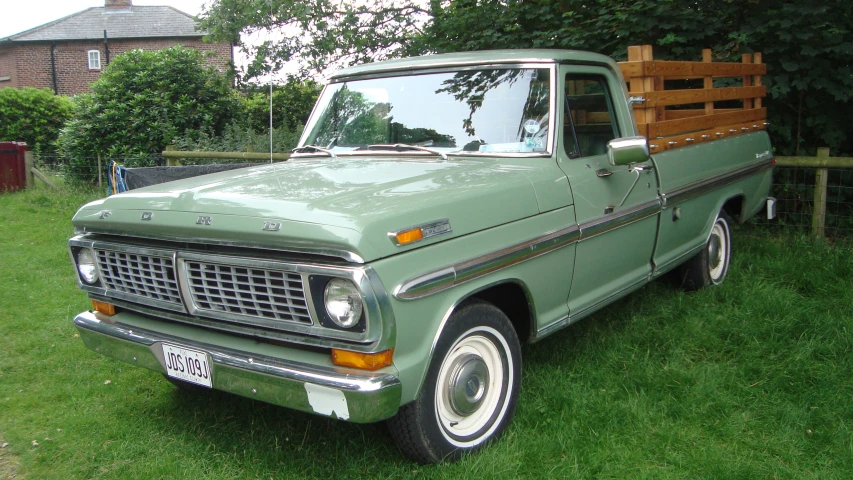 an old pick up truck is parked on the grass