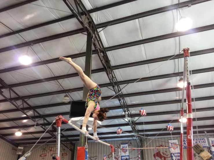 a person doing gymnastics on a parallel bar