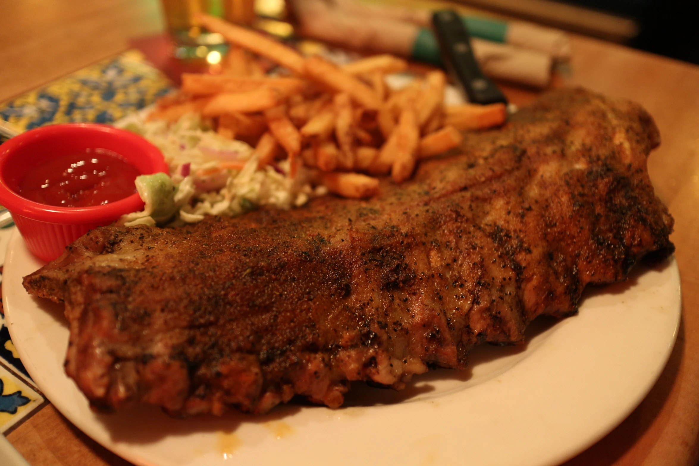 a large steak and fries are sitting on a plate