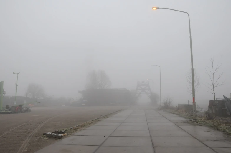 an empty street with a small light in the middle