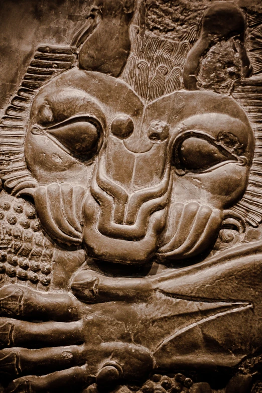 a close - up of an animal face carved into stone