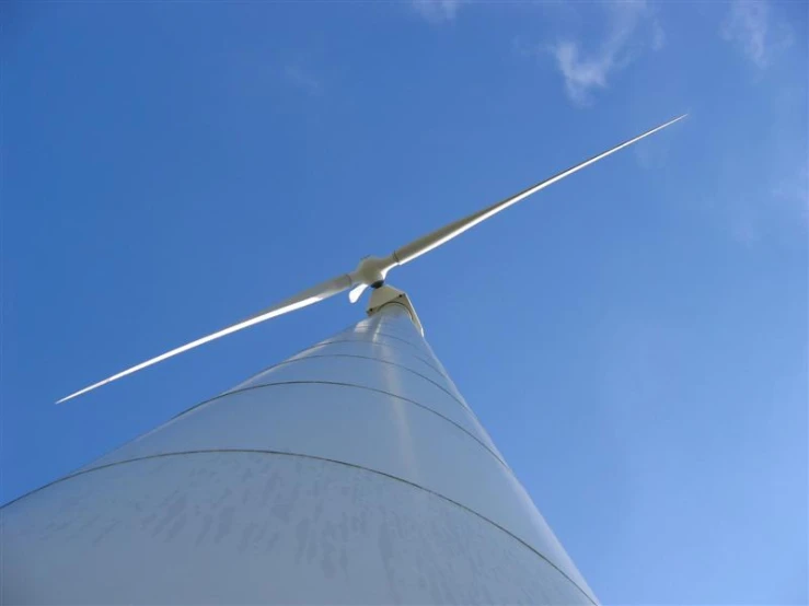 the wind turbine is shown on the blue sky