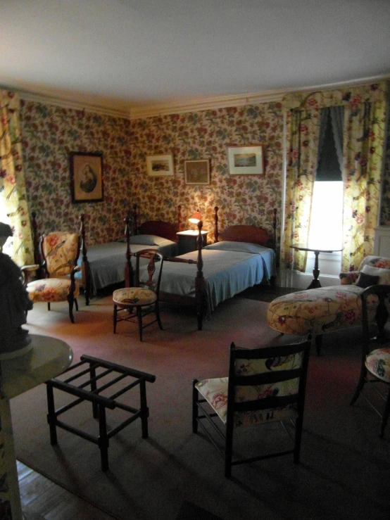 an antique styled bedroom is shown with two beds