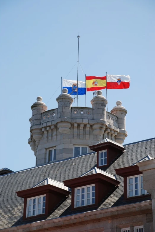 a flag and a building with windows and roof