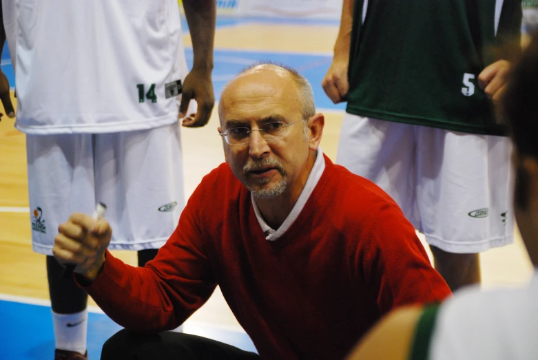 a man in a red shirt on a basketball court