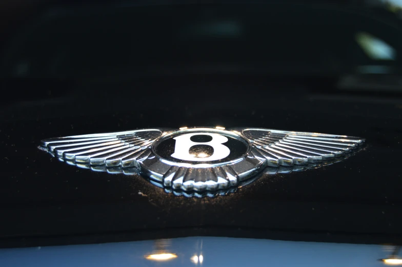 a bentley logo is shown on the hood of a black car