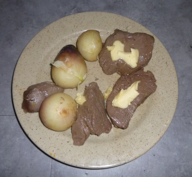 a white plate with some potatoes and brown sugar