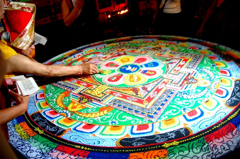 a person is painting a table on top of a round rug