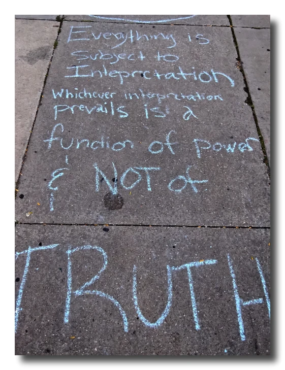 a sidewalk with chalk writings that read everything is true