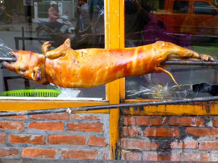 a fake pig sitting in a window sill