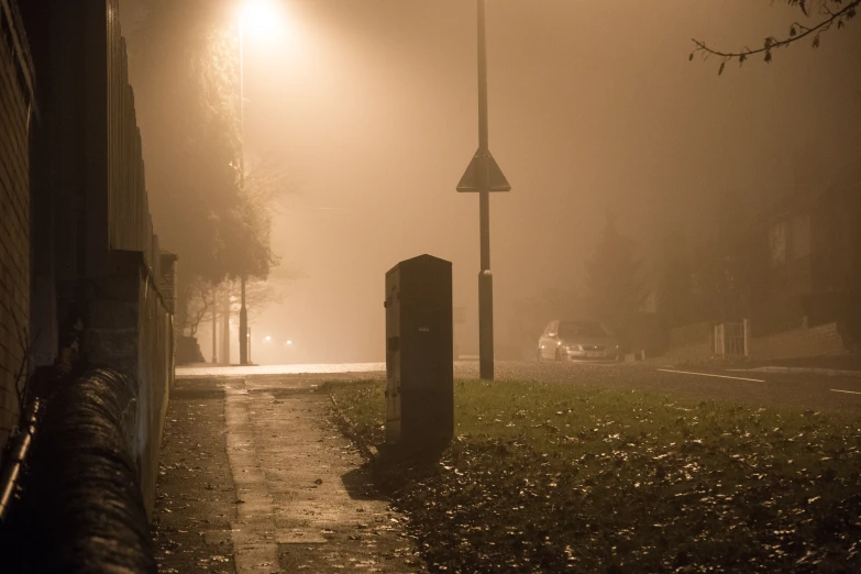 streetlights shining in the fog on a cold, rainy day