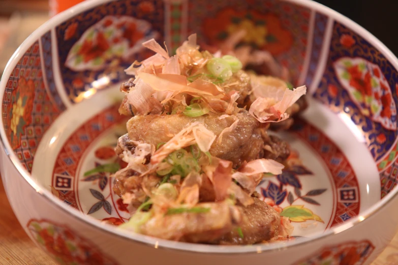 a bowl with meat and vegetables in it