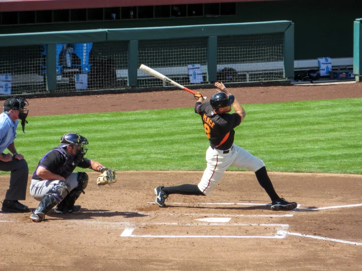 a baseball player taking a swing at a ball