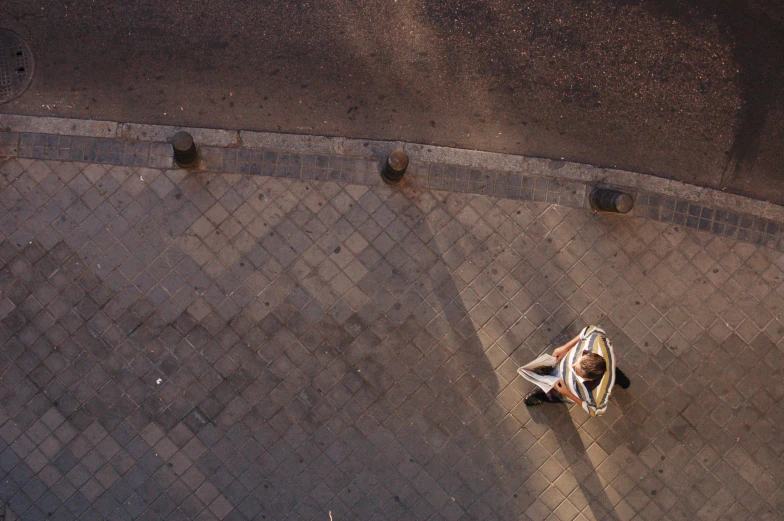 an overhead view of two people riding down the street