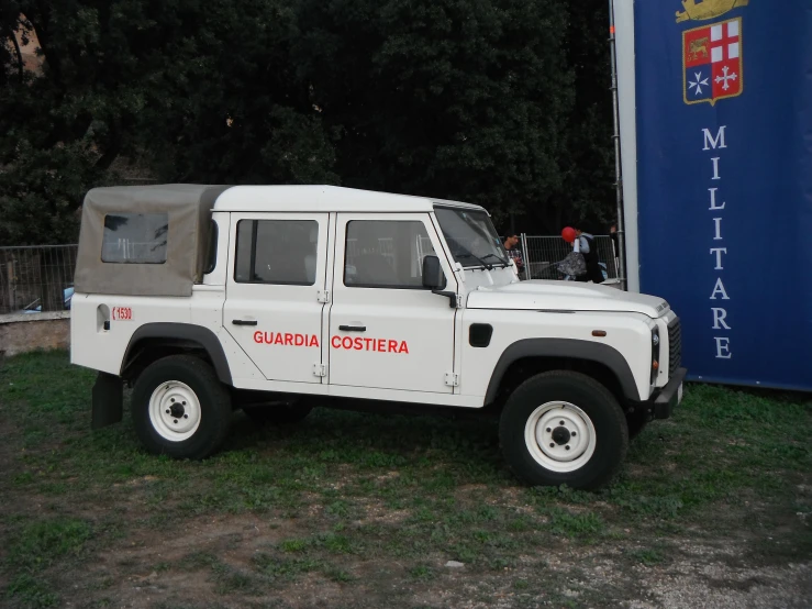 a white truck is parked in a grassy field