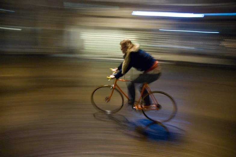 a man riding a bike down a street next to traffic