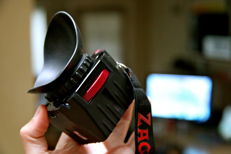 a close up of a persons hand holding a camera