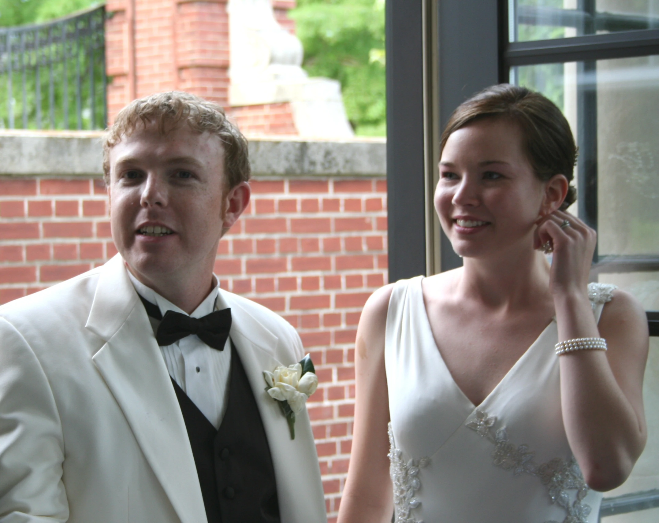 the bride and groom are standing near each other