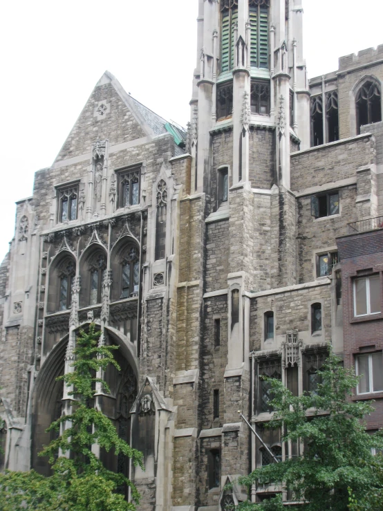 an old cathedral with a tall tower and green ivy