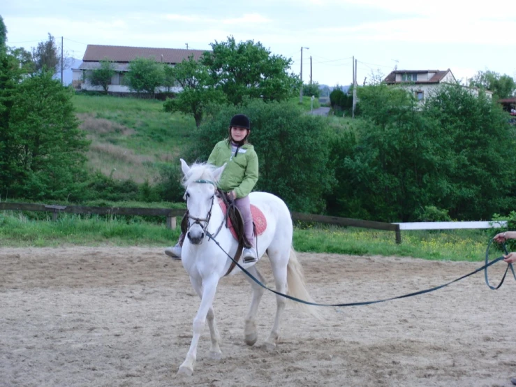  in green riding on top of a horse