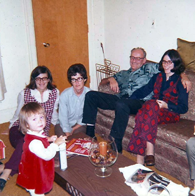 this is a family sitting around a table with their drinks