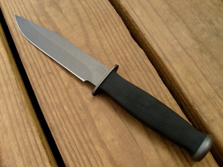 a large knife on top of a wooden table