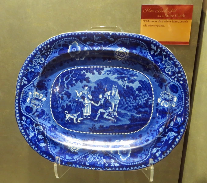 a fancy blue plate sits on display at a museum