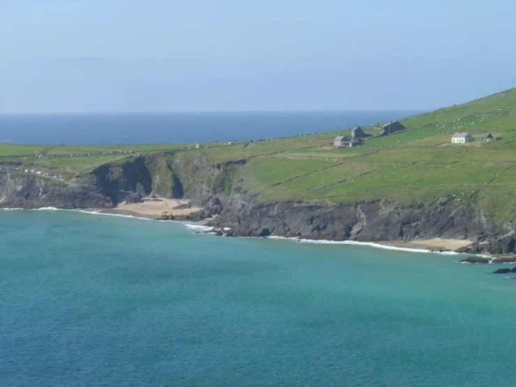 an aerial view of some houses on a hill overlooking the ocean