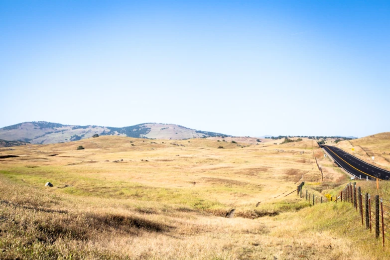 a po taken from a field with mountains in the distance