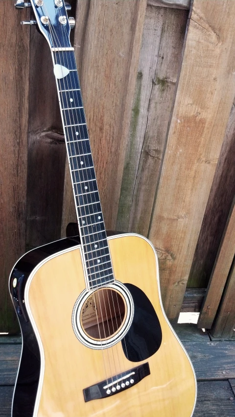 a guitar sitting on top of a wooden floor