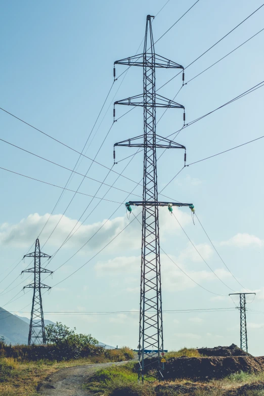 several electric wires and utility poles against a blue sky