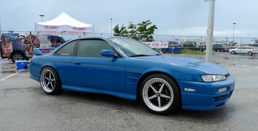 a blue car in a parking lot