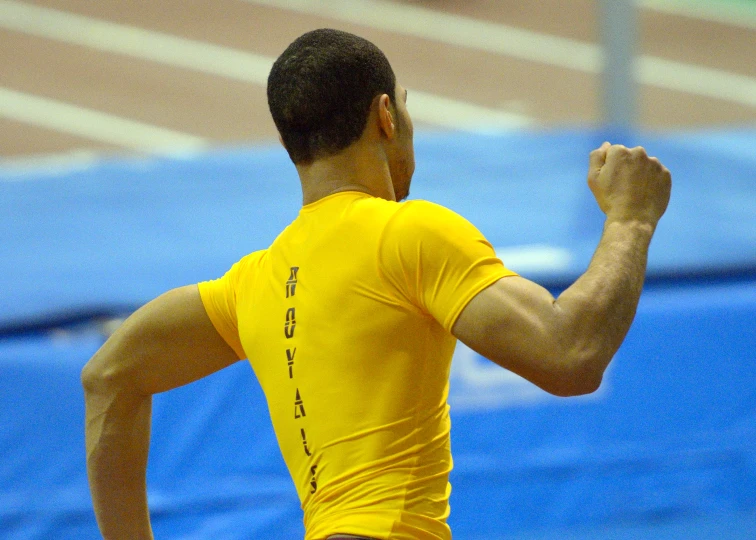 a male with a yellow shirt is in the middle of a game