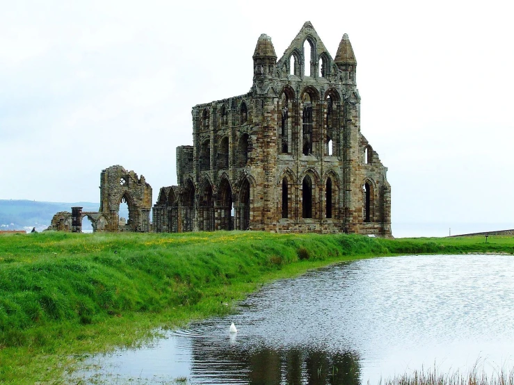 the ruins of a castle, located in a field