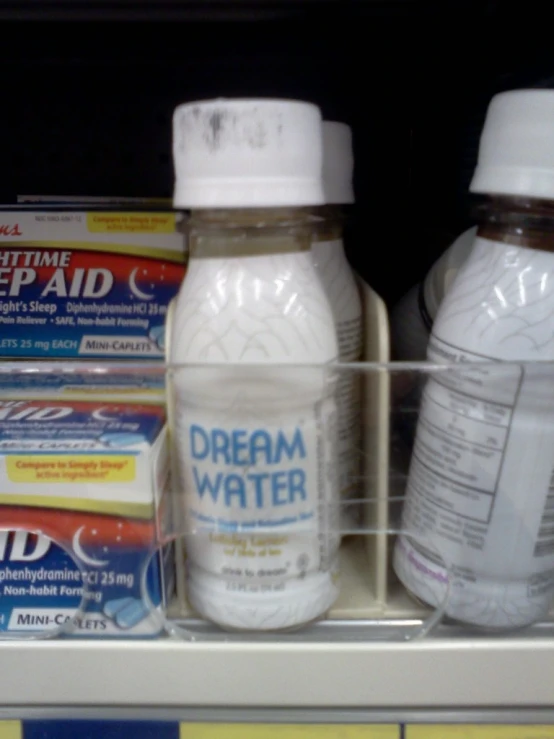 a shelf with some bottles and a tube of toothpaste on it