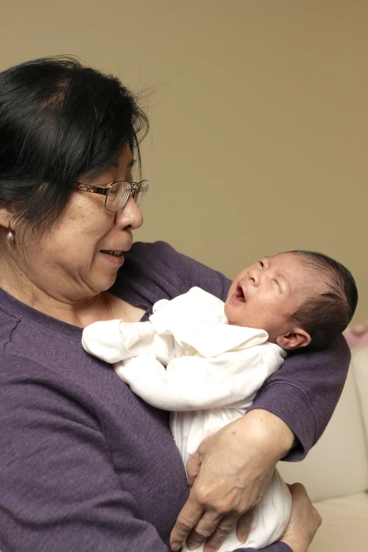 a woman holding a baby who is sleeping in her arms