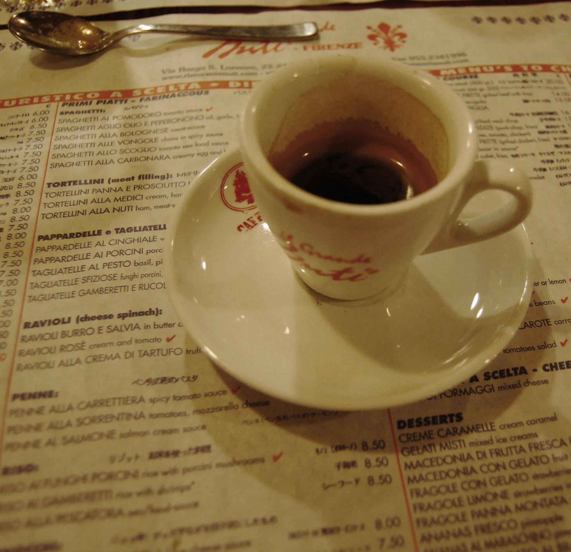 a cup of coffee sitting on top of a white saucer