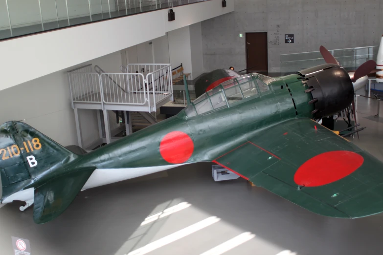 this old fighter plane sits on display in a museum