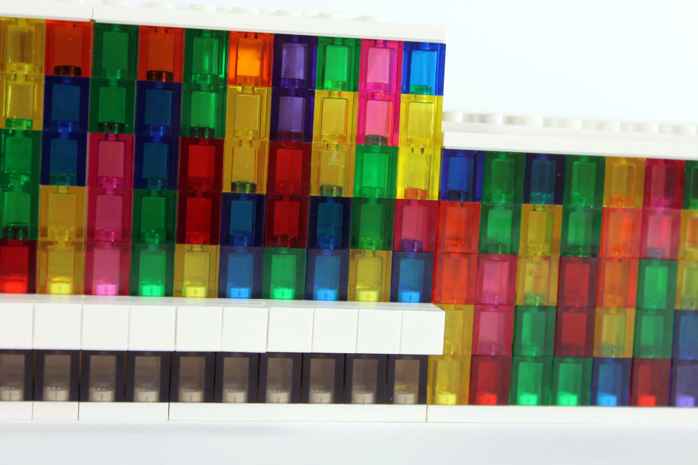 an odd building with a multi colored stripe of legos