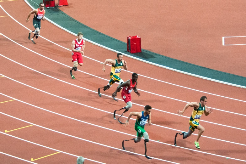 athletes running on an outdoor track together in the process of race