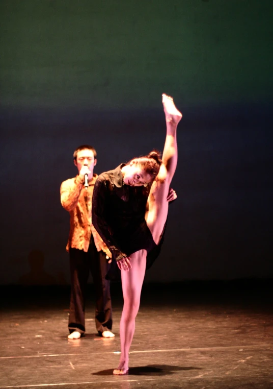 the man and woman are dancing on the stage