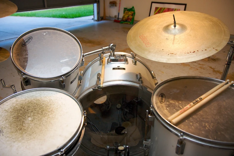 drum set up with drum sticks and drum case