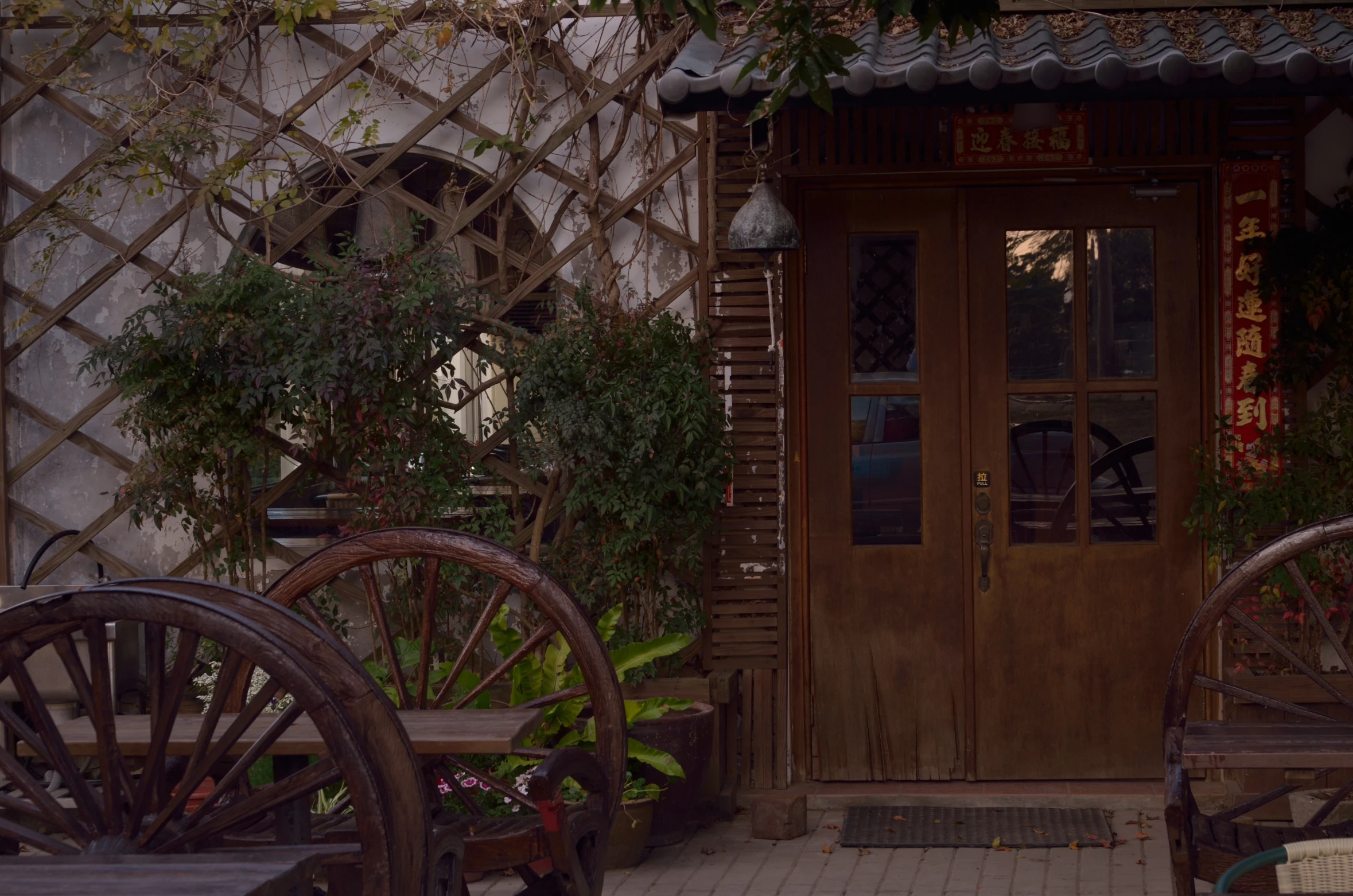 a set of wooden chairs in front of a wooden door