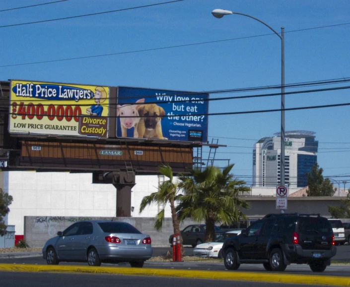 a billboard advertising a pet store along the side of the road