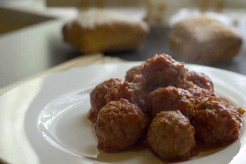 a plate with some meatballs and bread on it