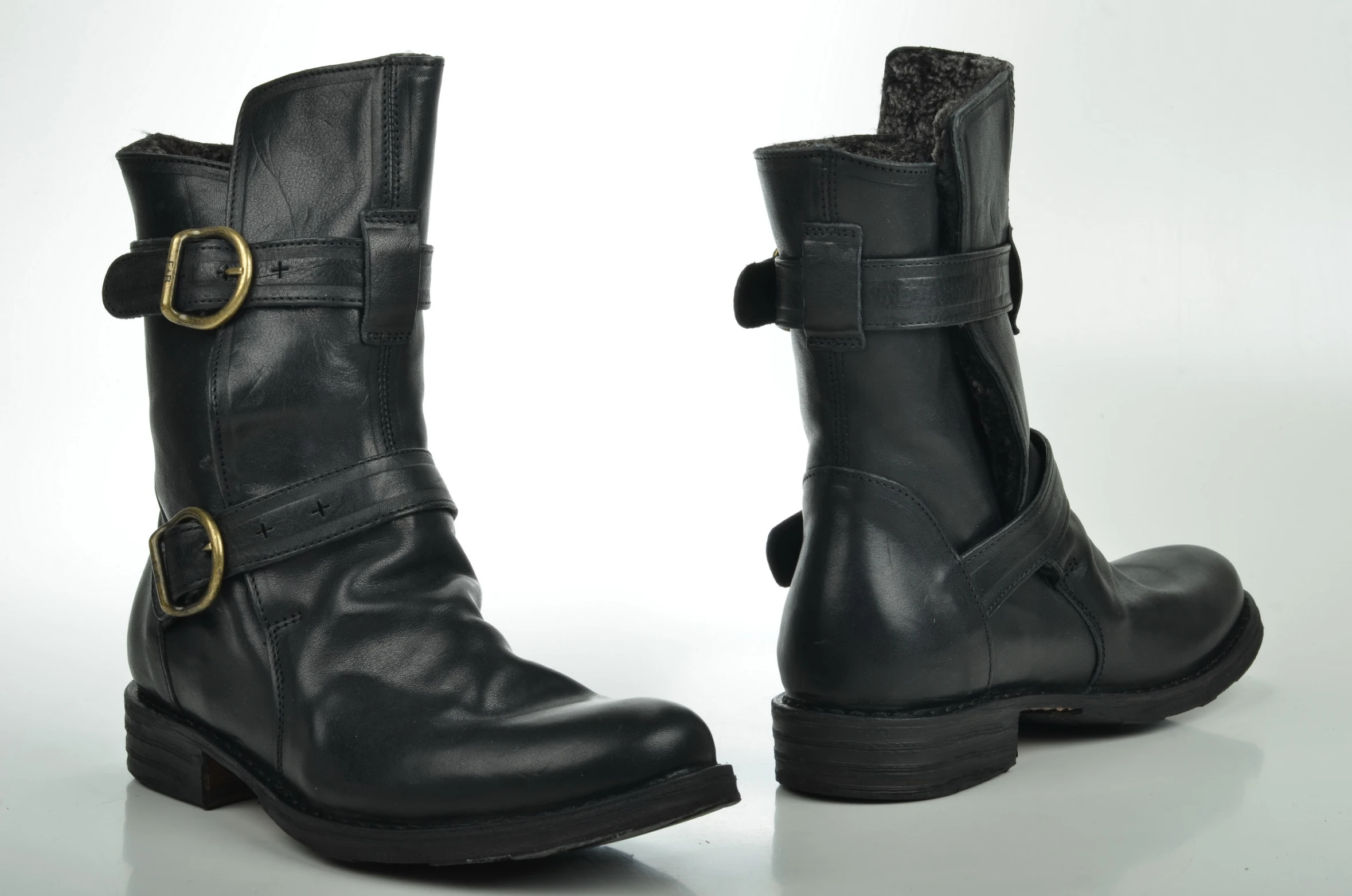 black leather boots with two golden buckles