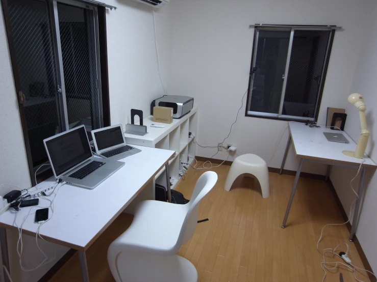 the interior of an office area with three computers