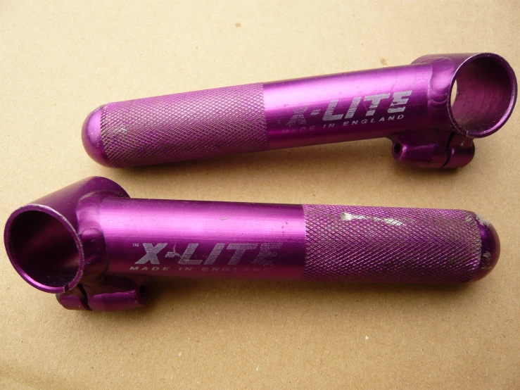 two purple aluminum air intakes that say air max