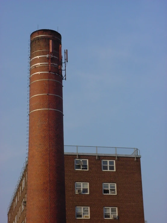 a tall brick tower near a tall building